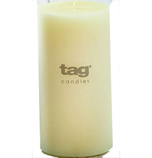 An ivory/off-white candle. Text on it say "Tag Candles."