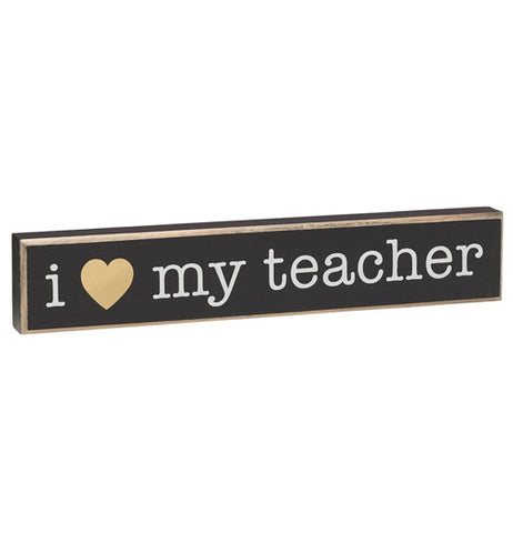 The "Love My Teacher" Sitter Sign has white text reading "I Love My Teacher"along with a gold foil heart to replace the word, Love, over a black background. 