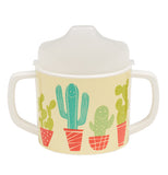 A light yellow sippy cup with a desert theme of potted cacti