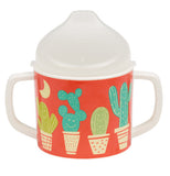 A reddish-orange sippy cup with a desert theme of potted cacti 