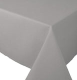 The Rectangle "Spectrum" (60x90) Tablecloth is gray-colored and folded on the end of the table. 