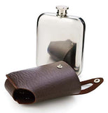 This silver bottle was taken out of the dark brown leathered flask and traveling case.    