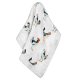 The white swaddle blanket with the multi-colored chickens is shown on its own.