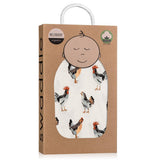 This white swaddle blanket featuring a design of multi-colored chickens is shown inside its cardboard packaging.