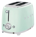 a pastel green colored toaster with 2 slots on top, on the right side of the word SMEG. the front has a slider and bellow it are two buttons, one has a snowflake, the other a heat symbol, between them is a knob that controls the cooking.