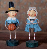 The Tom pilgrim is shown standing next to a female pilgrim figurine.