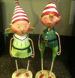 The male and female green elf figurines are shown standing together.
