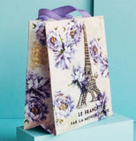 The same Small "French Kiss" Tote Bag is seen from the side on a blue box against a blue background.