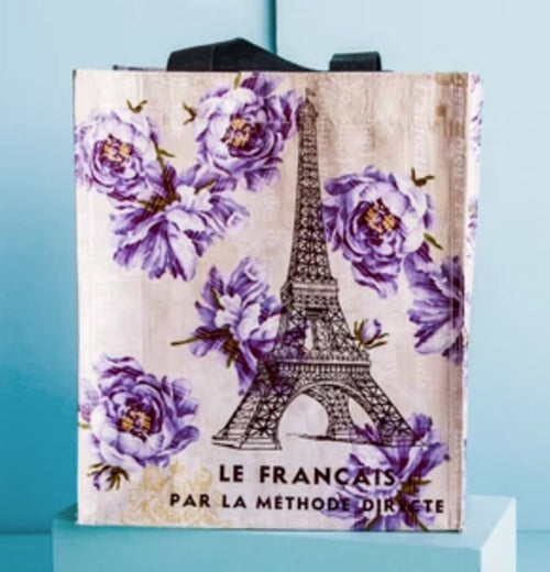 The Small "French Kiss" Tote Bag sits on a blue box against a blue background.