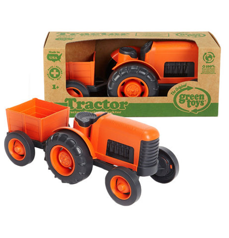 Orange and black six wheeled Tractor with trailer attached to it made from recycle materials with the package in front. 
