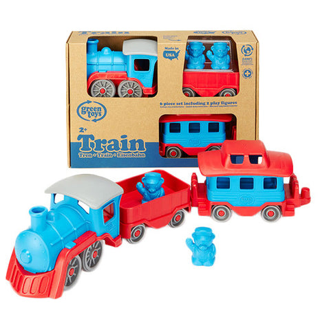 its a red and blue train grey wheels with one car and a caboose with two blue figures. Behind it is the train set in its packaging.