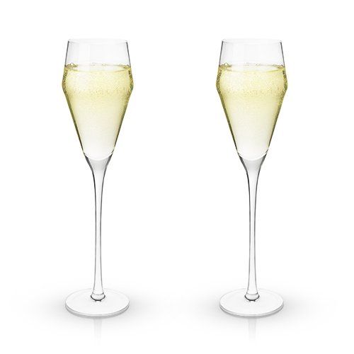 Set of 2 clear crystal "Prosecco" glasses with angled design filled with white wine over a white background.