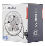 The box that contains the silver metal fan is shown with a picture of the fan on the front. Above the picture of the fan are the words, "USB DESK FAN" in gray lettering against a white background.