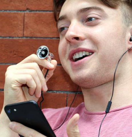 A person is shown operating the megaphone device connected to his phone.