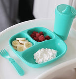 The "Aqua" Spill Proof Cups sits on a white high chair tray with a matching divided plate and fork. 