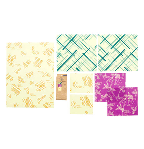 Variety pack of reusable food wrap laid out separately. One Bread size and two small in honeycomb print, two Medium size in purple clover print, and two Large teal geometric print.