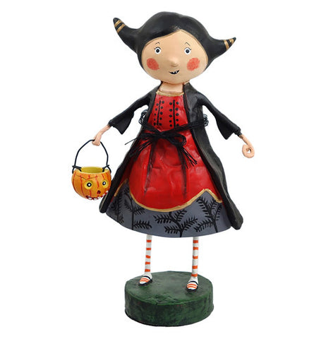 Veronica the Vampire figurine wearing a black jacket and a red, yellow, and black dress and red and white socks. She is holding a kitty candy bucket