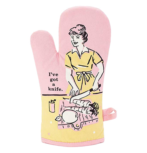 A pink oven mitt showing a women chopping a carrot and also features the text "I&