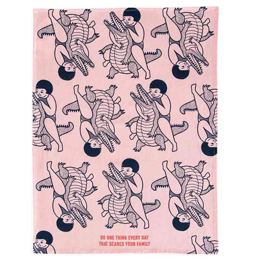 This same "Scares Your Family" dish towel shows the entire design of more girls wrestling with alligators.