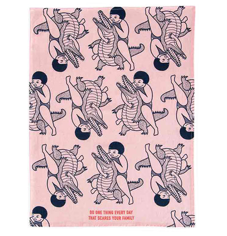 This same "Scares Your Family" dish towel shows the entire design of more girls wrestling with alligators.