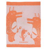 The "Hangry" dish towel has an orange and pink design with three wolves waiting to eat holding knives and forks.