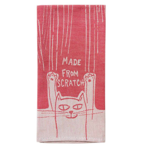 This red cotton towel has a design of white lines at the top, and a cat at the bottom. The stretching cat is shown in red lines against a white background. Above the cat are the words, "Made From Scratch".