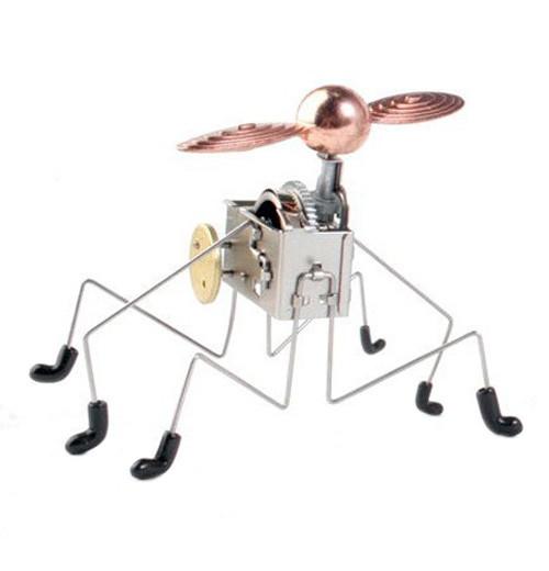 This six legged wind-up Pintacuda robot toy has a motor and a gold propeller that when turned on it moves all around and the propeller turns.