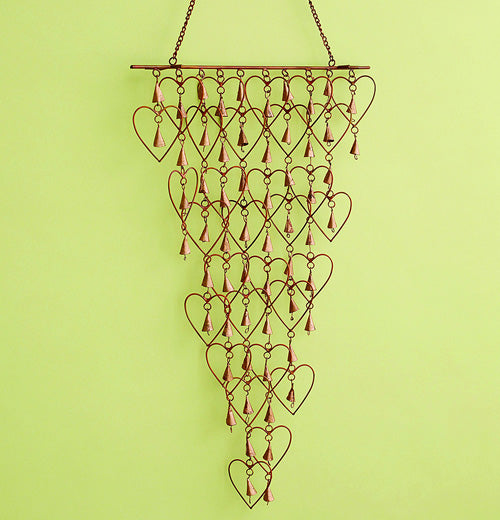 Shimmering Bells with Hearts wind chime over a green background with bells inside hearts.