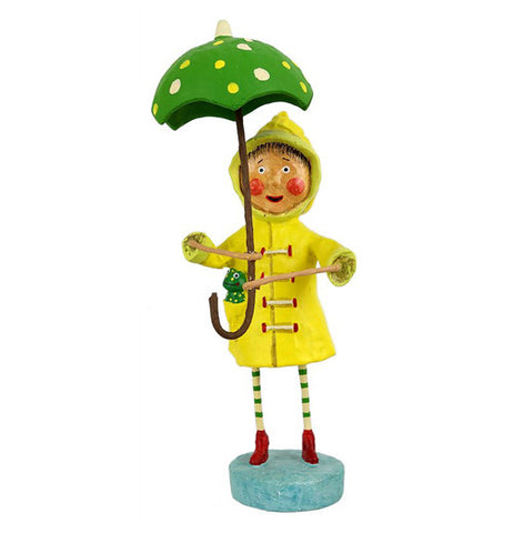 This little girl figurine wears a yellow rain jacket and red boots with a green frog in her jacket pocket. She holds a green umbrella with yellow spots.