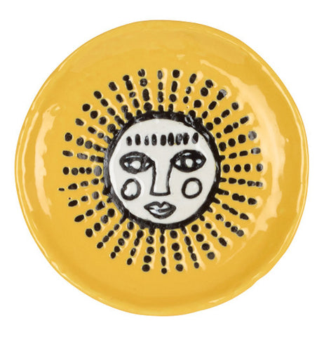 This ceramic yellow coaster has a white sun with a face