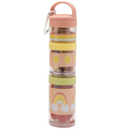 Multiple, plastic stackable snack containers are pastel pink, yellow, green, and transparent in color. A steel carabiner hangs off a small handle. The snack containers are stacked together. There is food in the containers.