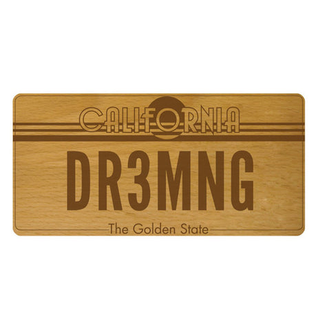 A beechwood cheese board that says "DR3MNG" on it.