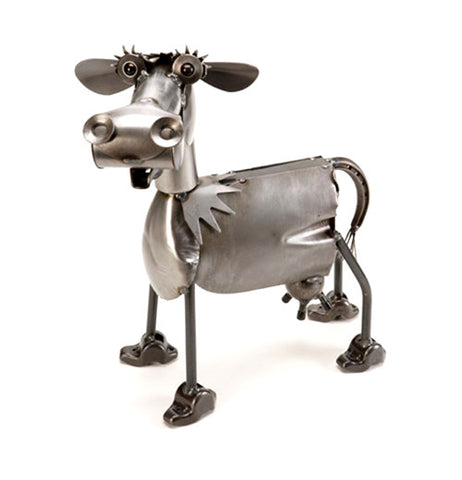 This metal sculpture is of a cow with large hooves.