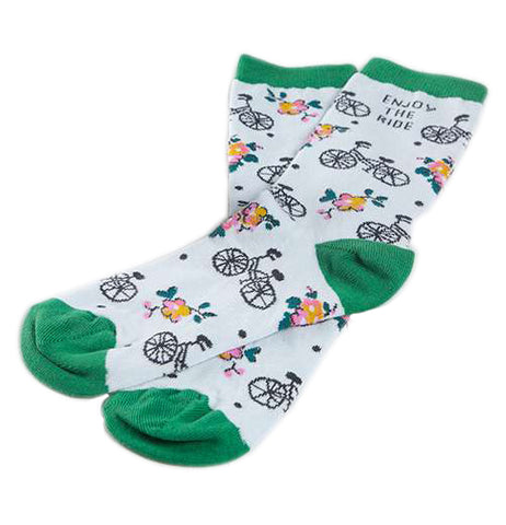 White socks with a pattern of bikes and flowers that have green at the calf, heel, and toe and says "Enjoy the ride".