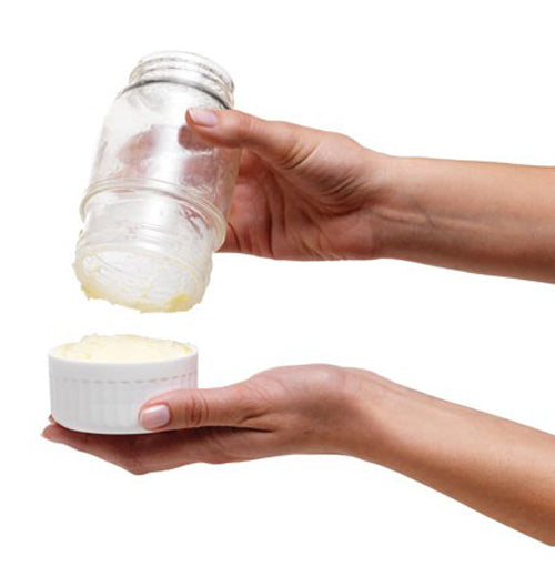 Someone is emptying out the made butter into a ramekin.