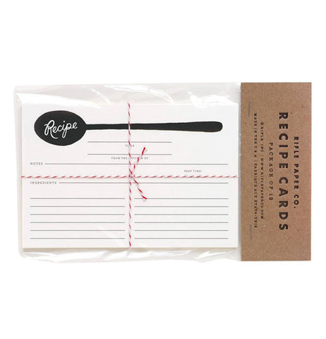 White cards for recipes with a black spoon at the top in a clear plastic package with cardboard top.