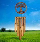 Tree of Life Bamboo wind chimes against a blue sky and a grassy field.