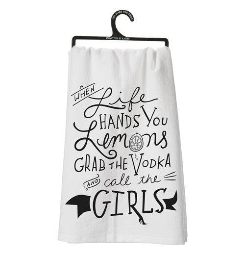 Dish towel with black text on it.
