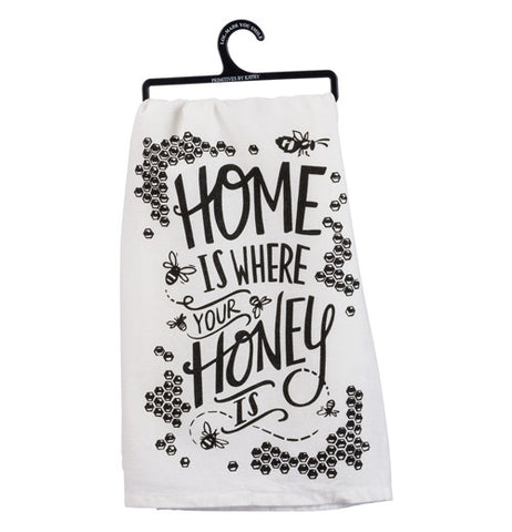 A white cotton dishtowel. Honeycombs and bees frame the edge.