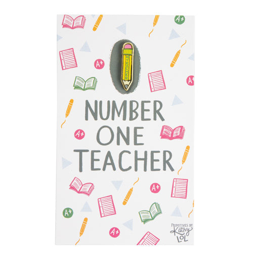 Yellow enamel pencil pin with #1 Teacher written on it.  It's attached to a post card decorated with school related pictures.