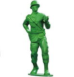 A green plastic army man toy holding a walkie-talkie.