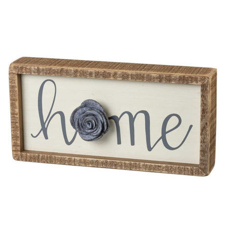 The Inset "Home" Box Sign has a box that says, "Home" with a gray felt flower over a white background. 