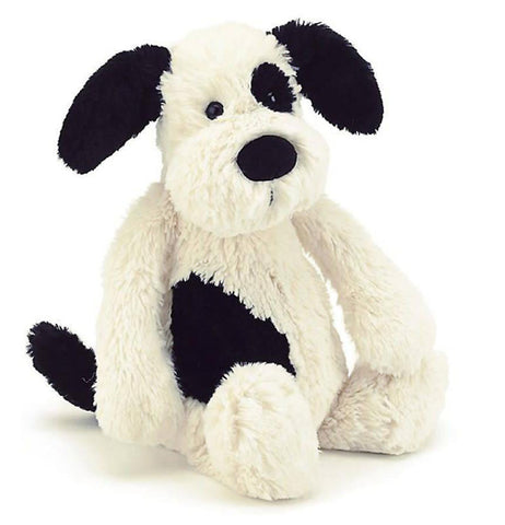 a picture of a white puppy with black spots