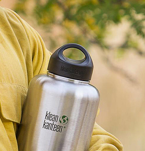 The steel black lid is shown sealing the top of a "Klean Kanteen" steel water bottle.