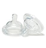 Two clear silicone baby nipples. One is sitting flat and the other is sitting partially on it at an angle.
