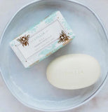 Lollia sugared pastilled soap with shea butter with light blue and gold with bee's on it out of the packaging