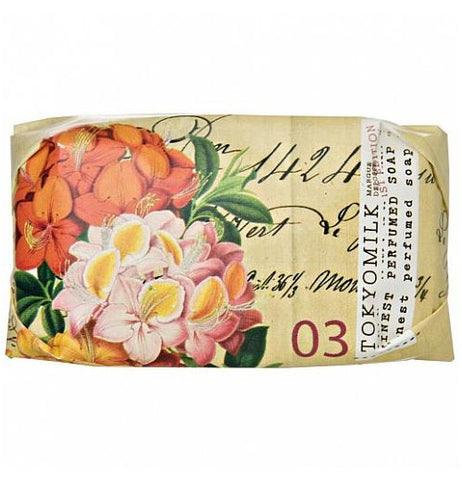 Tan mini soap with a large pink flower on it.