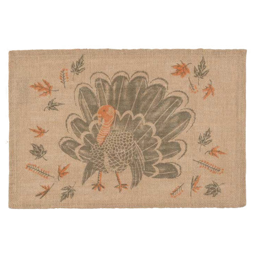 A brown placemat with a big turkey on it with different leaves.