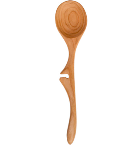 A wooden spoon with an indentation in the middle stands up straight.