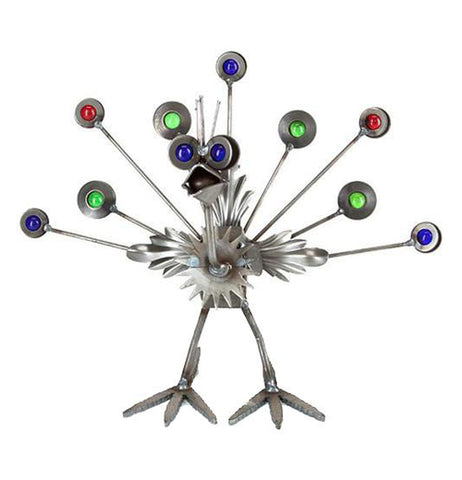 This metal sculpture is shaped like a small peacock with red, green, and blue marbles for its tail feathers.